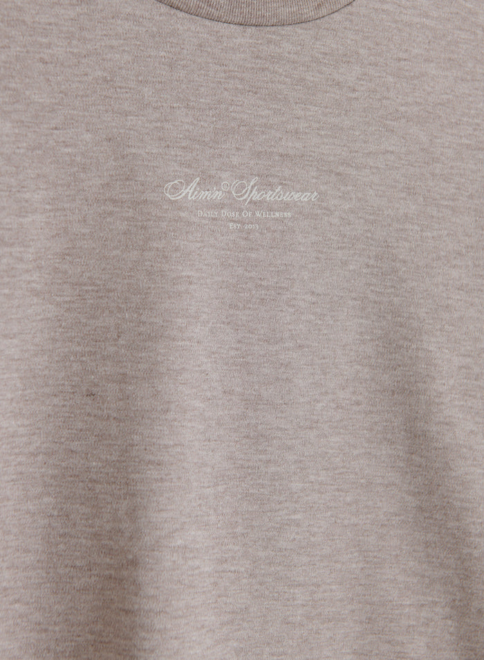 Espresso melange Script Boxy T-shirt featuring a white aim'n logo, crafted from soft organic cotton.
