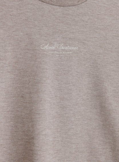 Espresso melange Script Boxy T-shirt featuring a white aim'n logo, crafted from soft organic cotton.