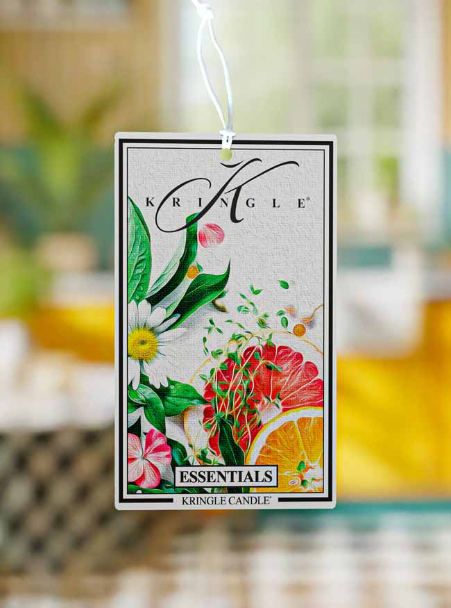 Kringle Candle air freshener tag with floral design on a blurred background