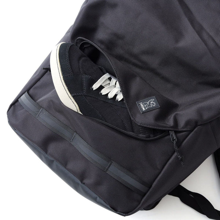 The front pocket holding a shoe of the Extlek 24L Backpack in black