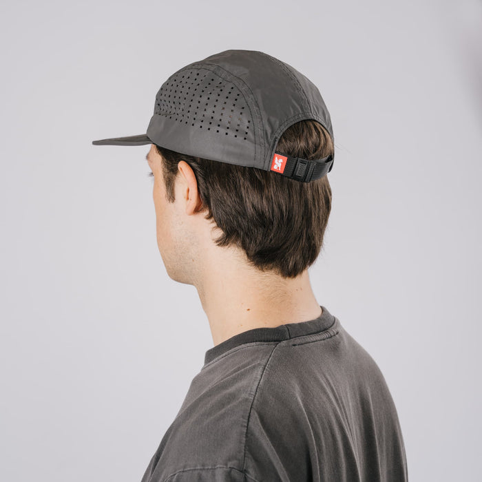 The back of the new Chrome Industries Five Panel Hat in black reflective on a guys head