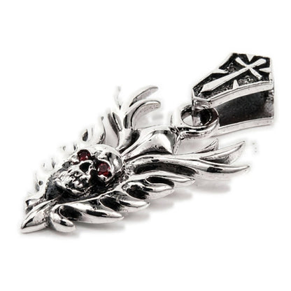 Macro detail of the skull face on the sterling silver pendant showing deep-red garnet cabochon eyes