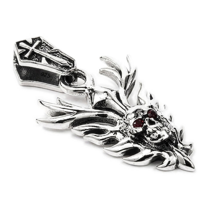Angled front view of the flame blade skull pendant in .925 sterling silver with deep-red garnet eyes