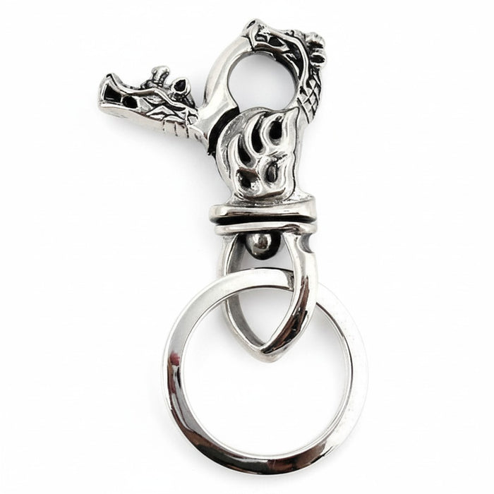 A handcrafted flame dragon keychain in 925 sterling silver on a white background.