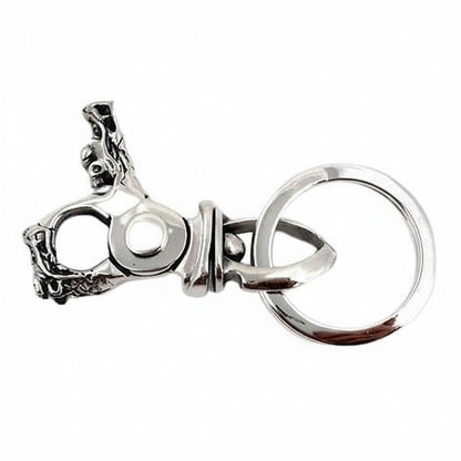 Edge view of the dragon head clasp, its pivot joint and spring clip visible beside the split key ring.