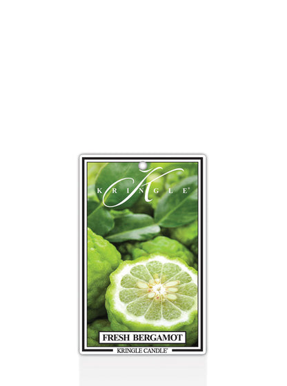 Kringle Candle Fresh Bergamot air freshener with green leaves and a lime slice on a white background