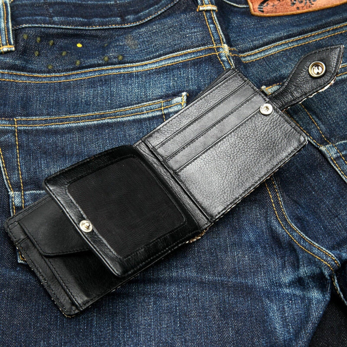 The fully open interior of the cobra skin wallet, showing the black leather card slots and secure button coin pocket.