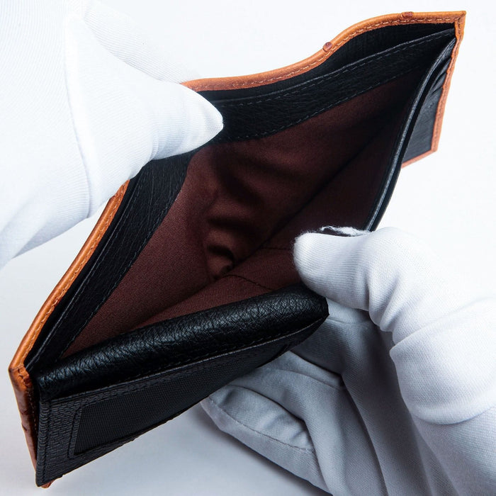 Showing the deep and spacious silk-lined bill compartment of the two-tone ostrich leather wallet.