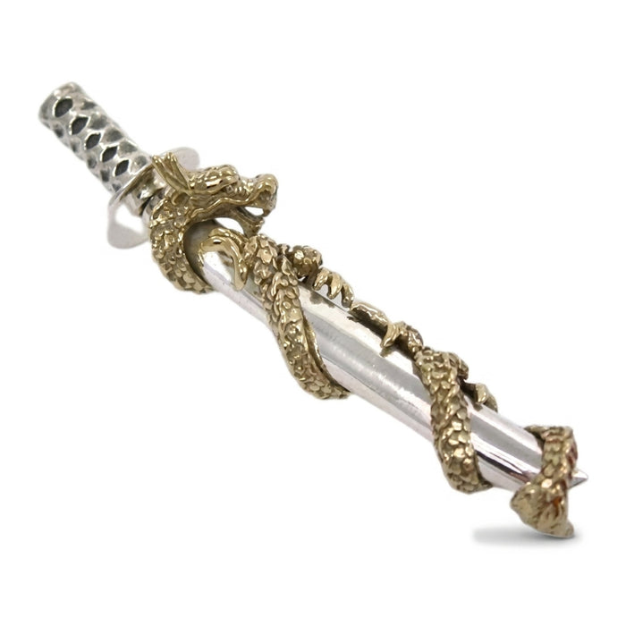 Dragon head with horns and claws gripping the sterling silver scabbard, oxidized gold sculpting detail visible