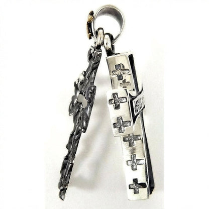 Side view of sterling silver Gothic cross pendant showing engraved cross motifs along the edges
