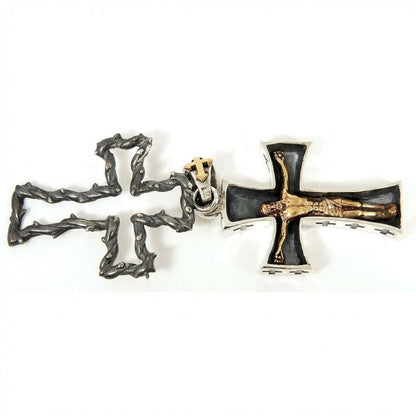 Flat lay of sterling silver crucifix pendant showing thorn frame and inner golden Jesus cross side by side