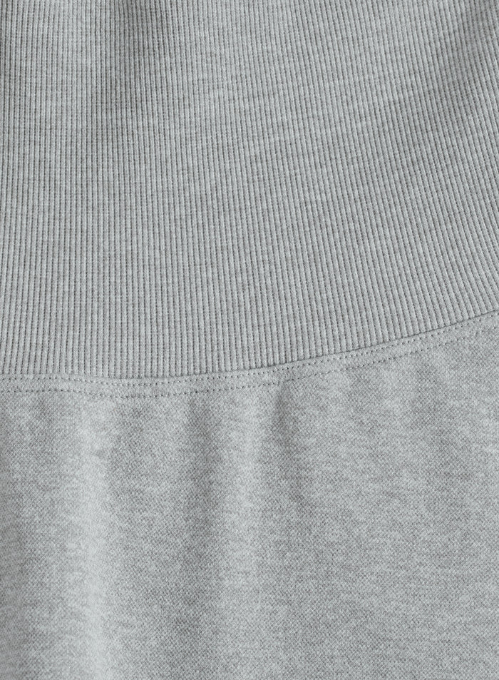 Close-up of the grey melange fabric and high ribbed waistband on these aim'n Shape Seamless Tights.