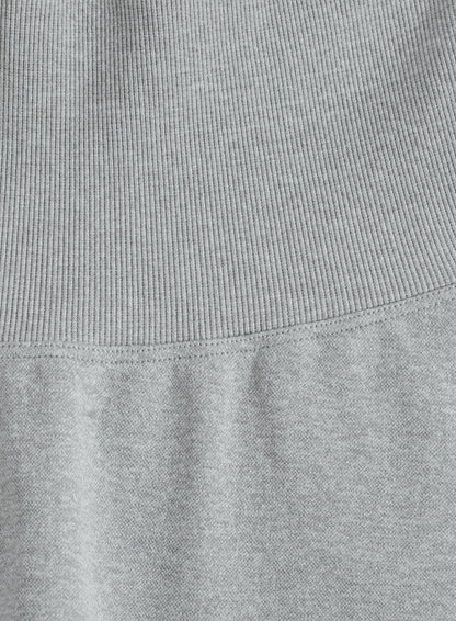 Close-up of the grey melange fabric and high ribbed waistband on these aim'n Shape Seamless Tights.