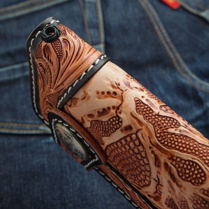 A close-up of the metal grommet for a wallet chain on the hand-carved leather wallet.