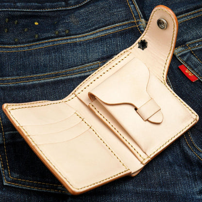 The interior of the tooled leather wallet, showing the unlined cowhide, card slots, and coin pocket.