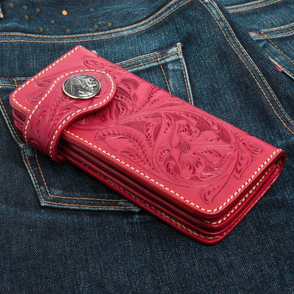 A unique, custom tooled leather biker wallet in a vibrant red, featuring classic Western-style floral patterns.