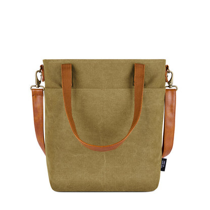 Sage green canvas tote bag with cognac brown leather handles and trim accents