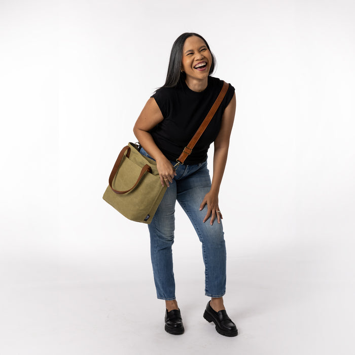Black, khaki, sage green, cognac brown, and blue denim clothing items arranged on white background