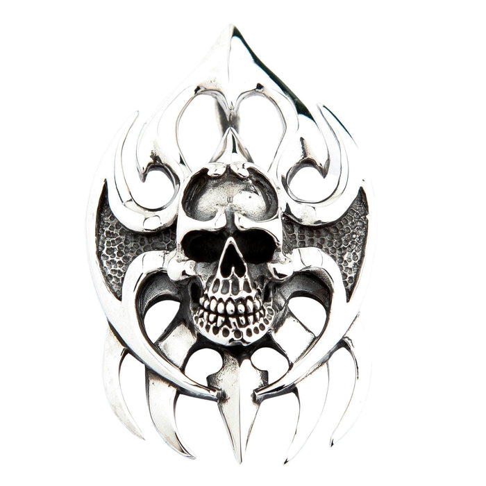 Close up of intricate skull carving on tribal blade background