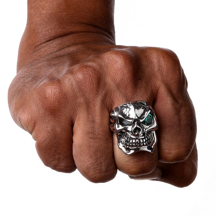 A front-on view of the green eye skull ring, highlighting the cracked cranium detail.