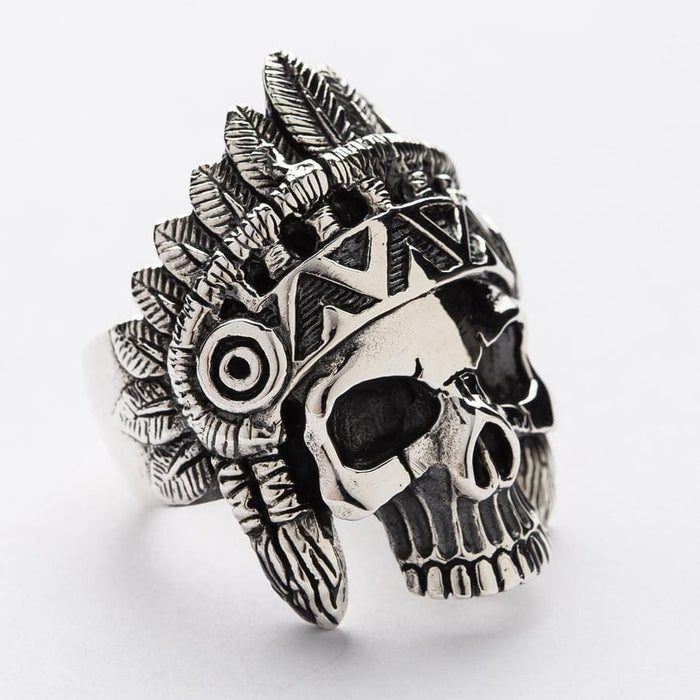 Side view of a handcrafted Indian skull ring, showing the detailed tribal patterns that continue along the band.