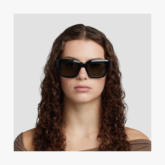 Crystal Emerald / Grey Green Lens | Front view of female model wearing Intrados Sunglasses in Crystal Emerald with Grey Green Lens