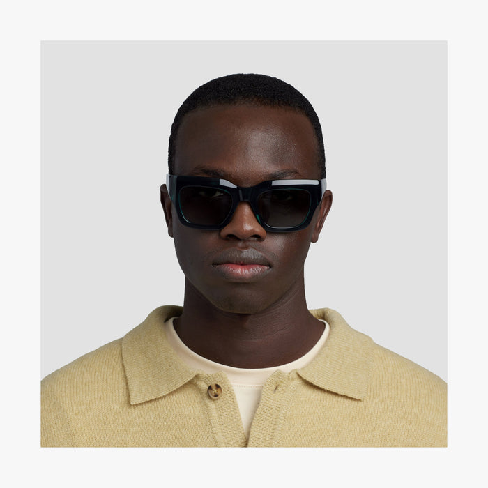 Crystal Emerald / Grey Green Lens | Front view of male model wearing Intrados Sunglasses in Crystal Emerald with Grey Green Lens
