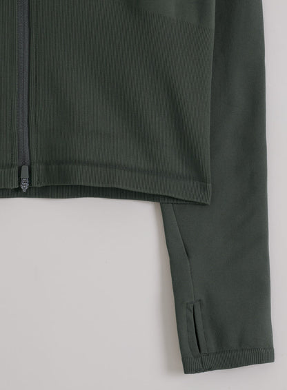 Ivy green aim'n Shape Seamless Zip Jacket featuring ribbed seamless fabric, a front zip, and sleeve thumbholes.