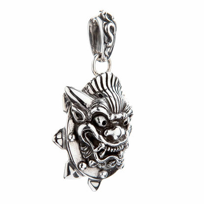 Angled profile of the solid silver Oni pendant highlighting the curling temple horn, spiked edge, and oxidized carving.