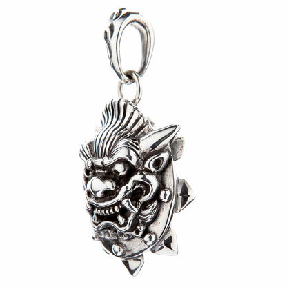 Side view of the oxidized silver Japanese demon pendant showing the bared fangs and spiked edge detail.