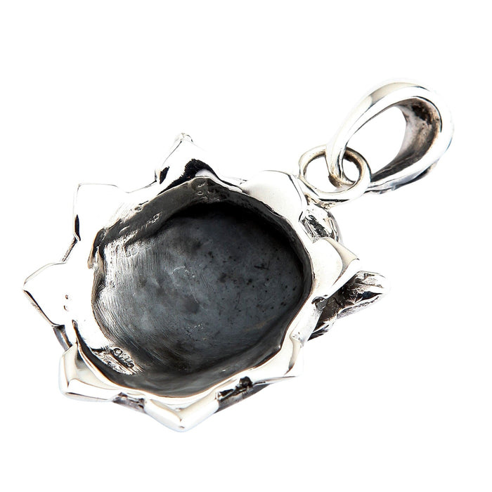 Concave back of the sterling silver mask pendant showing the hollow oxidized interior, 925 hallmark, and attached bail.