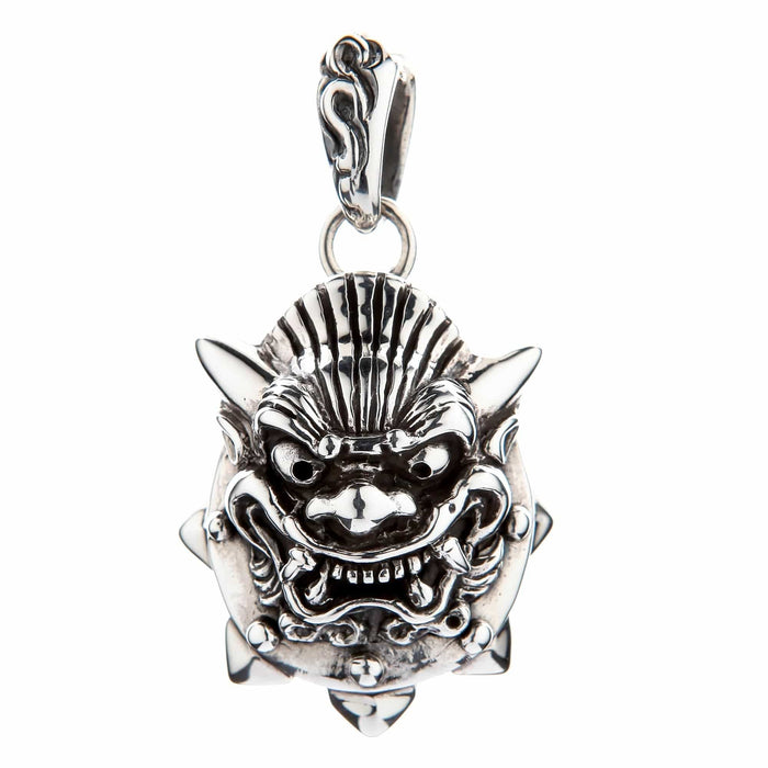 Detailed carving of the sterling silver Oni mask pendant, focusing on the ornate bail, spiked border, and bared fangs.