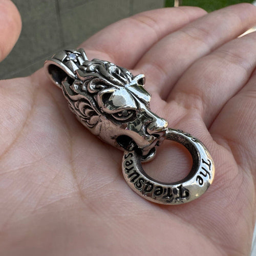 Angled view of sterling silver lion head pendant with door knocker ring