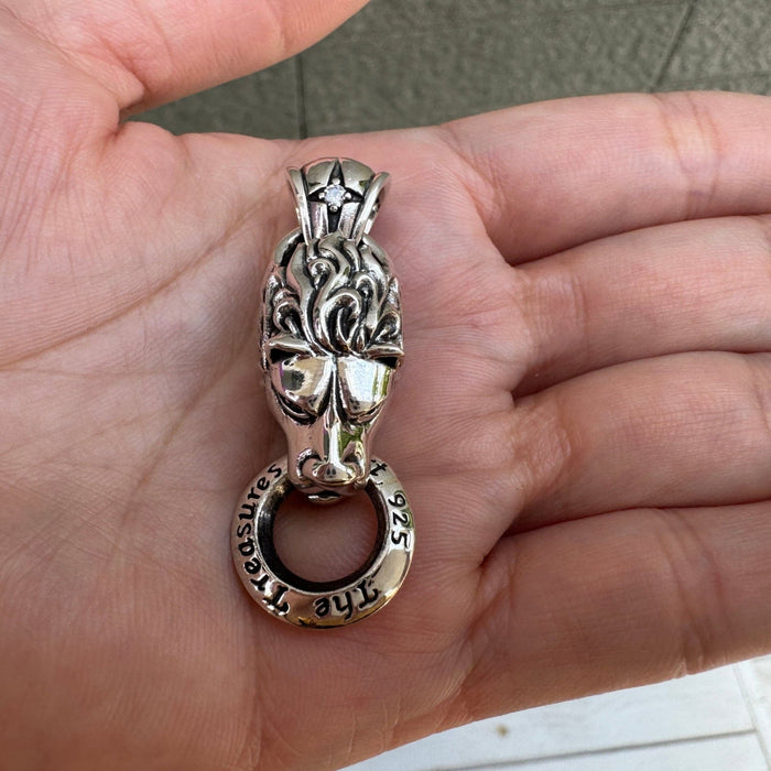 Front view of lion pendant featuring sparkling CZ diamond eyes