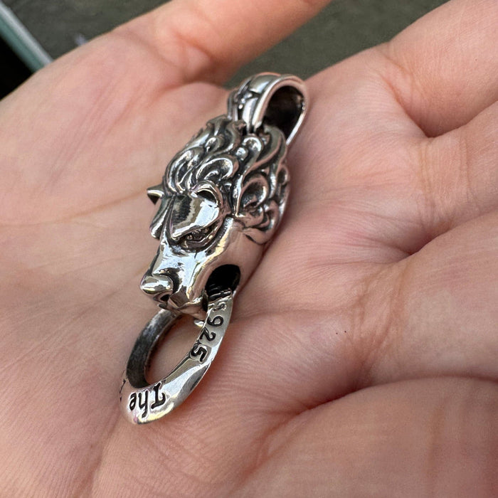 Side profile of heavy sterling silver lion charm showing depth