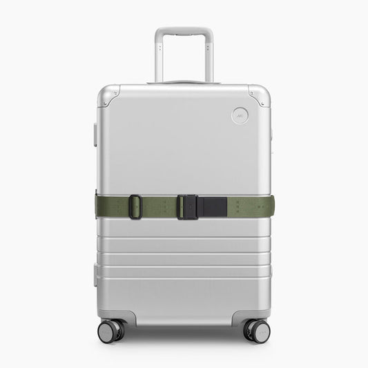 Olive Green | Front view of Aluminum suitcase with the Olive Green Luggage Strap secured around it