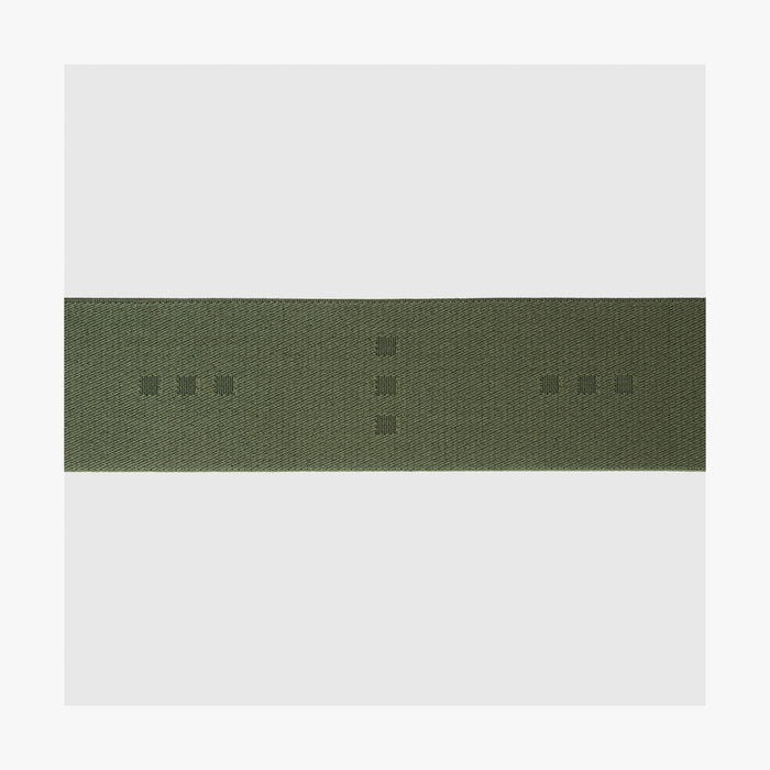 Olive Green | Close-up view of the logo detail on the Luggage Strap in Olive Green