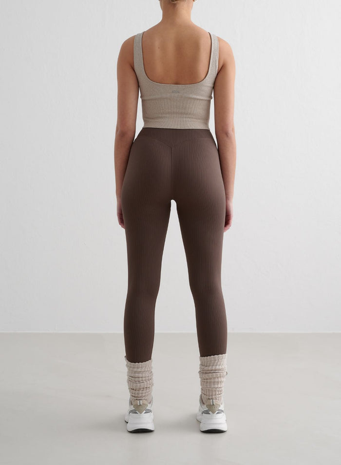 Brown aim'n Ribbed Seamless Petite Tights with a high-waisted fit and soft ribbed texture from behind.