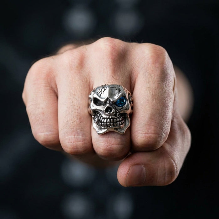 Heavy sterling silver skull ring worn on middle finger showing commanding presence