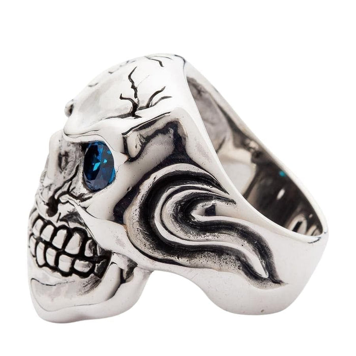 Right side view of sterling silver skull ring featuring swirl ear design and cracked texture