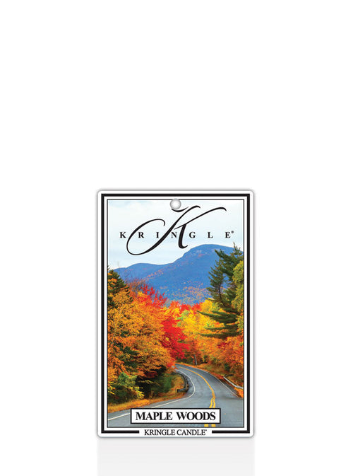 Kringle Candle Maple Woods air freshener with a scenic design of a road flanked by trees with autumn foliage.