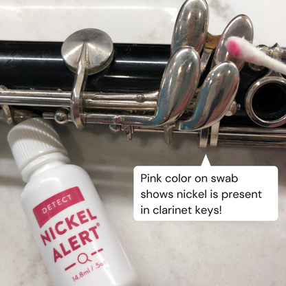Nickel Alert testing the keys on a clarinet. Pink color on swab shows nickel is present in keys.