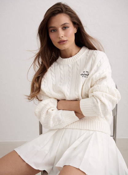 Off-white Club Cable Knit Sweater with aim'n logo, styled with a white pleated skirt. [M-174cm]