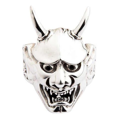 A polished solid silver Oni mask ring with sharp horns, isolated on a white background.