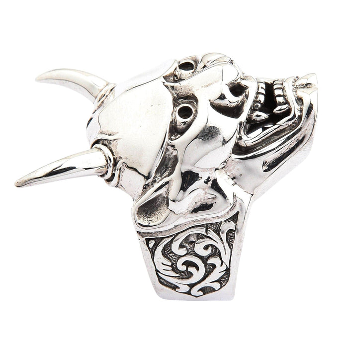 A close-up, angled shot of the Hannya mask ring focusing on the fangs and polished forehead.