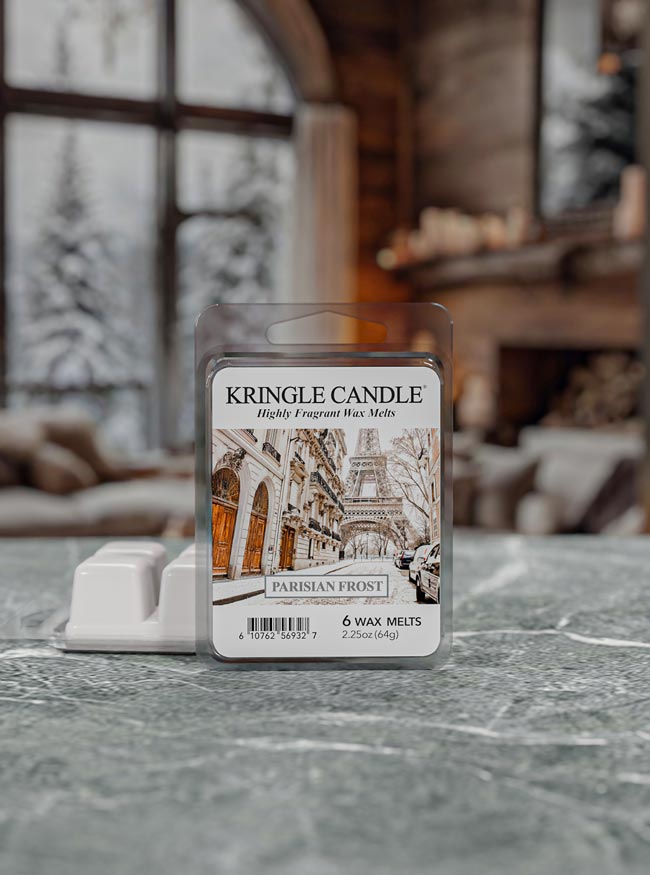 Kringle Candle wax melts packaging on a surface with a blurred background of a cozy room.