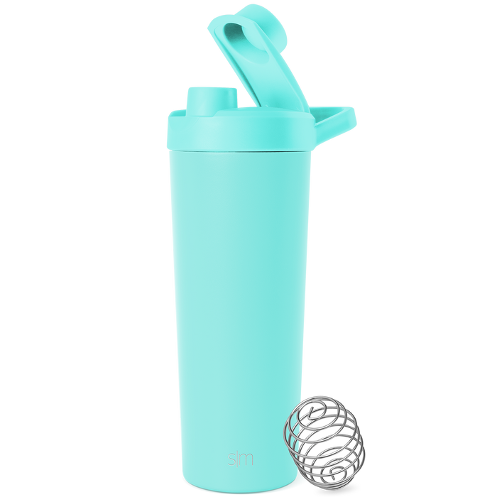 Soft pale turquoise container with stainless steel silver-gray mixing ball on white background