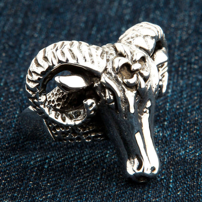 Angled profile highlighting the tight ridges of the curled horn and polished snout of the .925 silver piece.