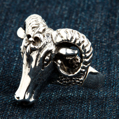 Three-quarter angle revealing the textured dimpled band and deeply carved eye of the solid .925 silver men's piece.