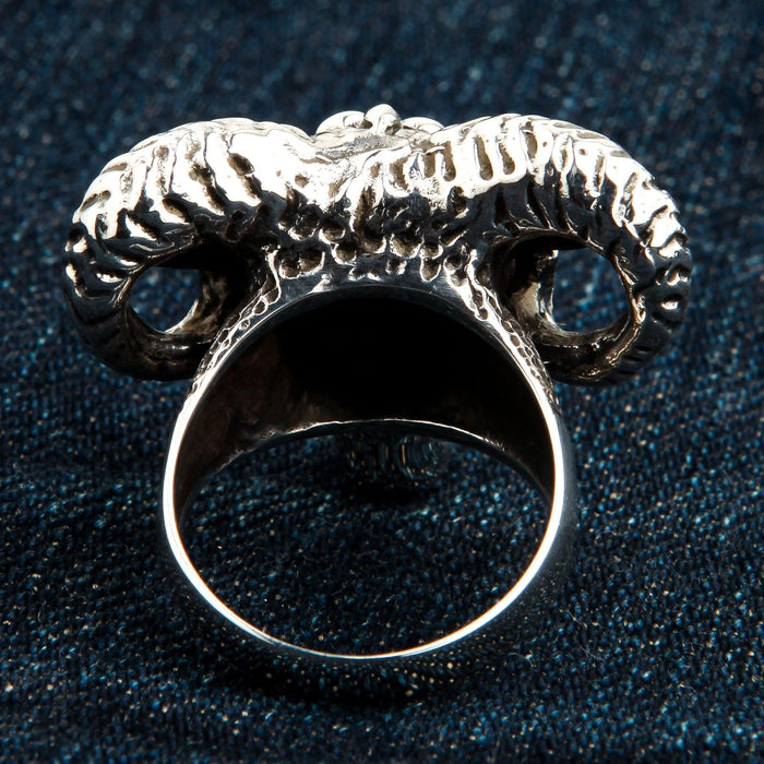 Back angle displaying the smooth interior of the 28-gram silver band beneath the deeply carved rear of the ram horns.